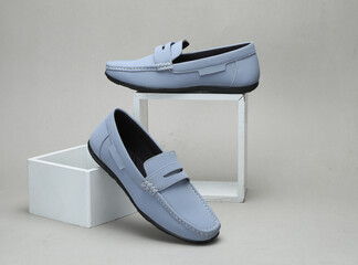 light blue leather loafers slip on shoes isolated on grey background