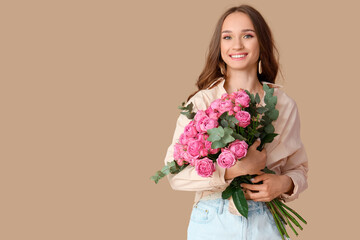 Beautiful young woman with roses on brown background