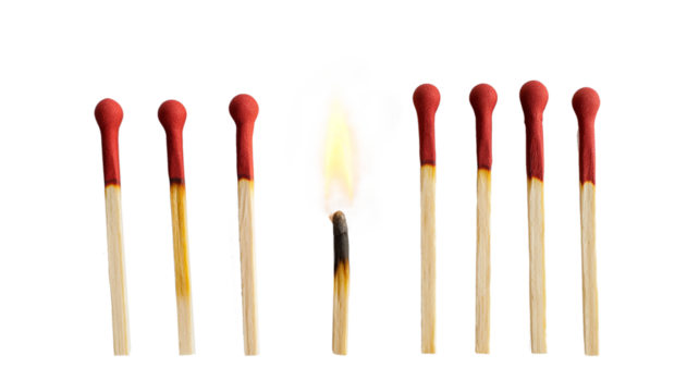 Lit match next to a row of unlit matches isolated on a transparent background