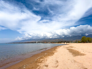 Sunny summer day on the lake. Mountains and sea. Kyrgyzstan, Lake Issyk-Kul