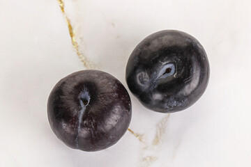 Two ripe sweet black plums