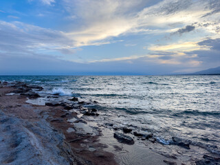 Sunny summer day on the lake. Mountains and sea. Kyrgyzstan, Lake Issyk-Kul