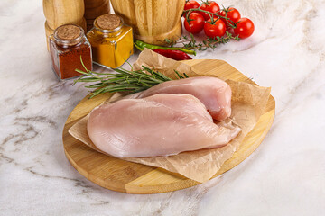 Raw chicken breast served rosemary