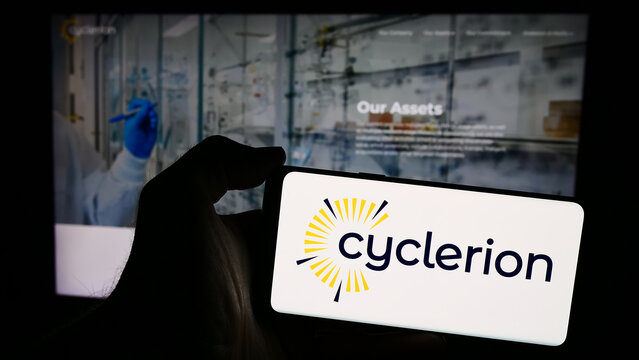 Stuttgart, Germany - 05-02-2024: Person holding smartphone with logo of US biopharmaceutical company Cyclerion Therapeutics Inc. in front of website. Focus on phone display.