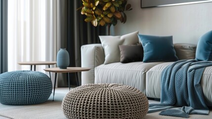 Stylish knitted poufs near the sofa in the living room. Interior element