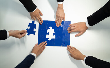 Top view panorama banner of business team assembling jigsaw puzzle over table symbolize business...