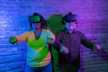 Senior Couple Exploring Virtual Reality in a Colorful Indoor Setting