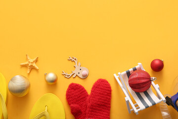 Composition with Christmas decorations, mittens and beach accessories on color background