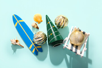 Composition with Christmas decorations, mini deck chair and surf board on color background