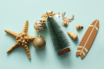 Composition with starfish, mini surf board and Christmas decorations on color background