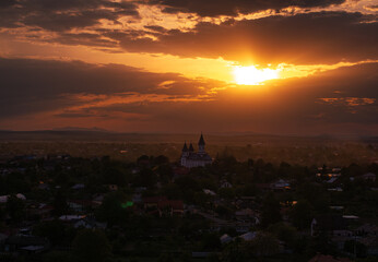 Cotu Vames Neamt Orthodox church in sunset light. Amazing aerial view during sunset over a landmark orthodox church in Moldova region from Romania. Church and Christian cross silhouette religion.