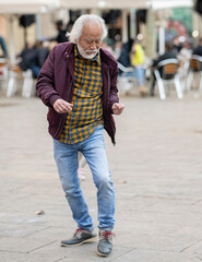 Senior Man Enjoying a Lively Dance on a City Square