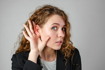 Young Woman Listening With Hand to Ear