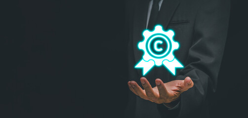 Copyright concept, Businessman hand holding copyright icon on virtual screen.