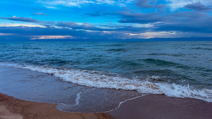 Fototapeta premium Big waves. stormy sea, thunderclouds. Kyrgyzstan, Lake Issyk-Kul