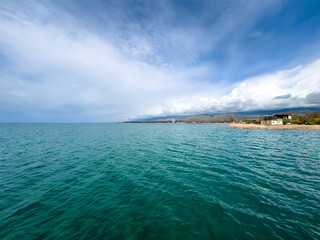 Sunny summer day on the lake. Mountains and sea. Kyrgyzstan, Lake Issyk-Kul