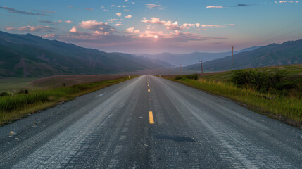Fototapeta premium Low level view of empty old paved road in mountain area at sunrise