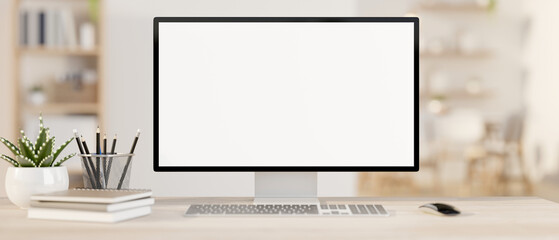A computer mockup on a wooden table in a contemporary minimalist white office or home office.