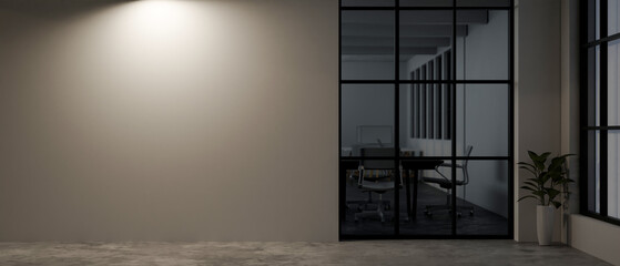 The interior design of a contemporary office corridor at night with a dim light on the empty wall.