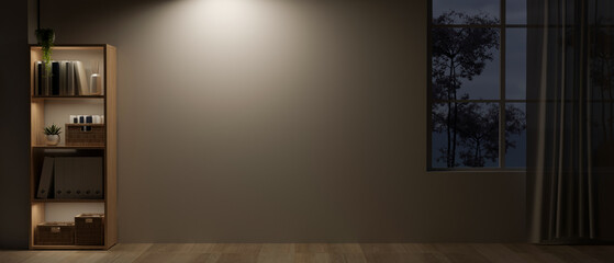 An empty room at night with a bookshelf, a dim light on an empty wall, and a rustic wooden floor.