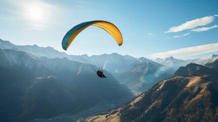 Paraglider flying over the mountains.