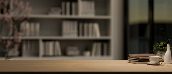 A copy space on a wooden tabletop in a contemporary room with a large bookshelf in the background.