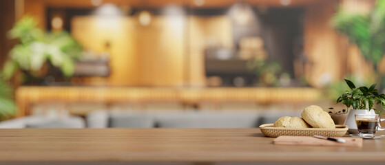 A copy space on a wooden tabletop features a bread basket and a coffee cup in a modern restaurant.