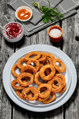 deep fried crispy onion rings on grey plate