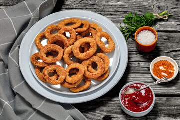 deep fried crispy onion rings on grey plate