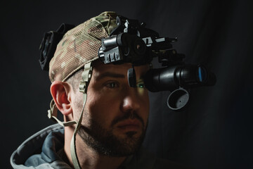A military man with night vision device on his head.