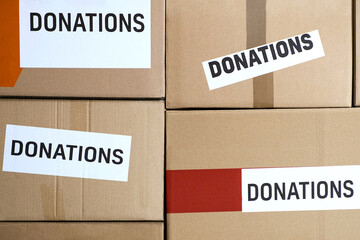 donations of food and medicine. Cardboard Boxes of donations and shelves with products at a small...