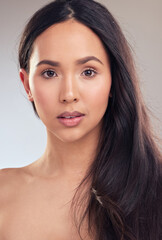 Woman, portrait and hair care in studio for health, wellness and skincare on gray background....
