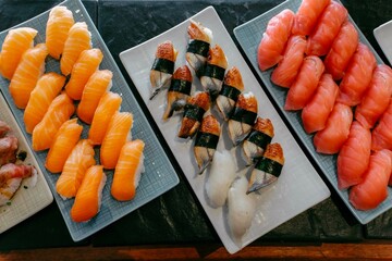 The composition of nigiri sushi with tuna, salmon, shrimp, butterfish on rice