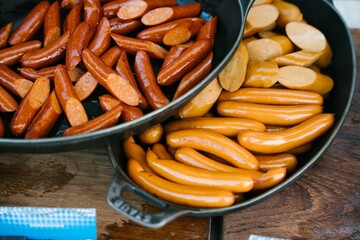 Grilled juicy sausages on a grill with fire. Shallow depth of field