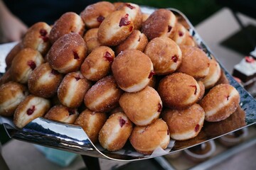 flying doughnuts scene - mix of multicolored sweet donuts with sprinkel on blue background