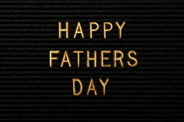 Inscription on a black board for Father's Day, on an orange background.