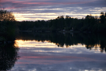 a beautiful purple sunset in the countryside by the river