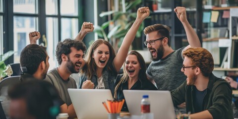 Enthusiastic team cheering over a successful achievement at the office