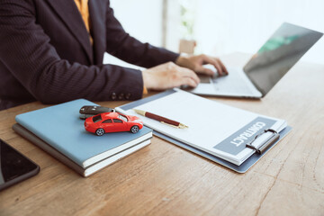 Close up businessman in formal dress working at desk. Automobile agreement insurance documents. Legal investment strategy for auto protection. Crash liability, expense, risk management for success.