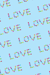 Multi colorued candies arranged on a bright blue background. Abstract pattern. Summer colors background. Minimal love pattern concept.
