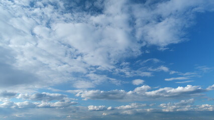 White and gray clouds fly across the sky and change shape. Clearing day and good windy weather. Timelapse.