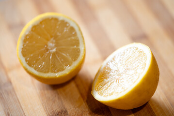 Lemon cut in two halves, close up. Fresh citrus laying on the table, yellow fruit, vitamins, good for health concept