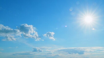 Beautiful scenic blue sky with rays of sun shining through clouds. Sun rays. Time lapse.