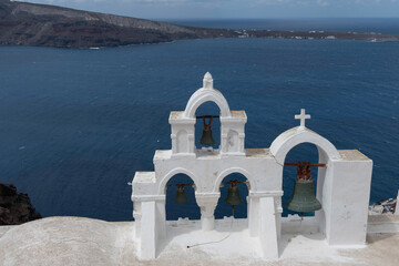 Santorini, Greece, May 5, 2024. Oia. Bells of St. Irene Church in front of the sea