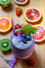  Strawberry and blueberry smoothie layer in a grass jar topped with fresh strawberry, blueberry, and chia seeds pudding, healthy summer fresh and refreshing breakfast drink