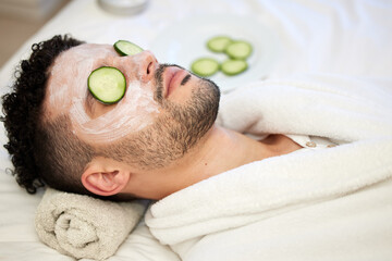 Skincare, face mask and man in spa with cucumber for vegan beauty, skin glow and dermatology...