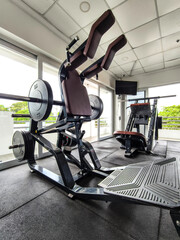 A hack squat machine and leg press machine at the gym.
