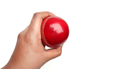 red cricket leather ball in player's hand on the white background