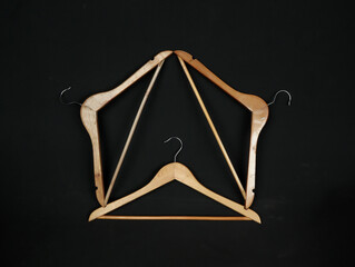 wooden hangers on the black background