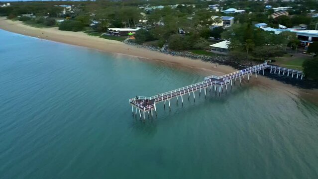 Drone View of Scarness Jetty in Hervey Bay, Qld Australia. Drone move around pier in late afternoon light. 